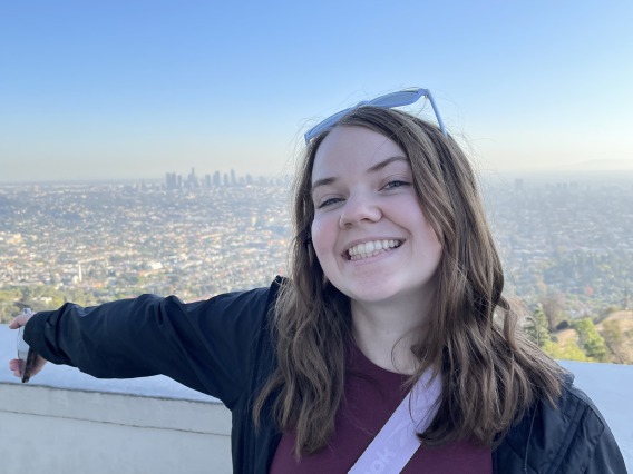 student pictured with city background blue sky