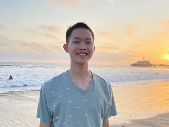 man standing on beach at sunset